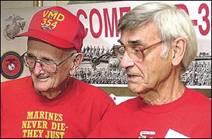 Former Marines Earl Vaughn, left, and Clarence Meyer revisit memories of their days in military service, when they were in the Pacific during World War II. Veterans of the squadron are holding their 18th reunion this weekend in Toledo. 