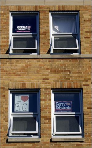 Signs in dorm room windows on the Bowling Green State University campus remind students of the Nov. 2 presidential election. Some students have been registering their peers during on-campus drives at BGSU amd at the University of Toledo and Tiffin University in Tiffin.