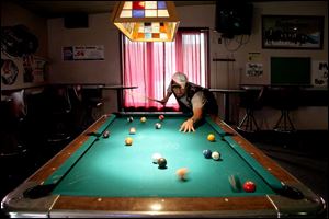 Khris Trull lines up his next shot on the pool table in the nonsmoking section at Myler's Rock Garden on Telegraph Road.