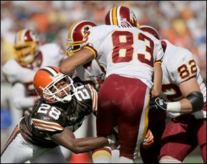 Cleveland's Leigh Bodden, left, holds on to tackle Washington's James Thrash (83) on a kickoff return in the third quarter to keep the Redskins pinned down deep in their own territory.