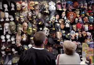 Customers survey the possibilities at Costume Holiday House on Monroe Street 