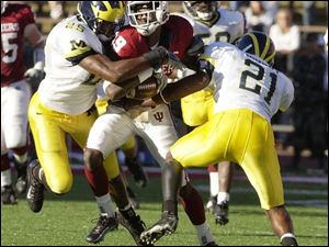 Ernest Shazor, left, wraps up Indiana's Courtney Roby. Shazor, a junior safety, leads the Wolverines in tackles with 40 and has seven tackles for loss.