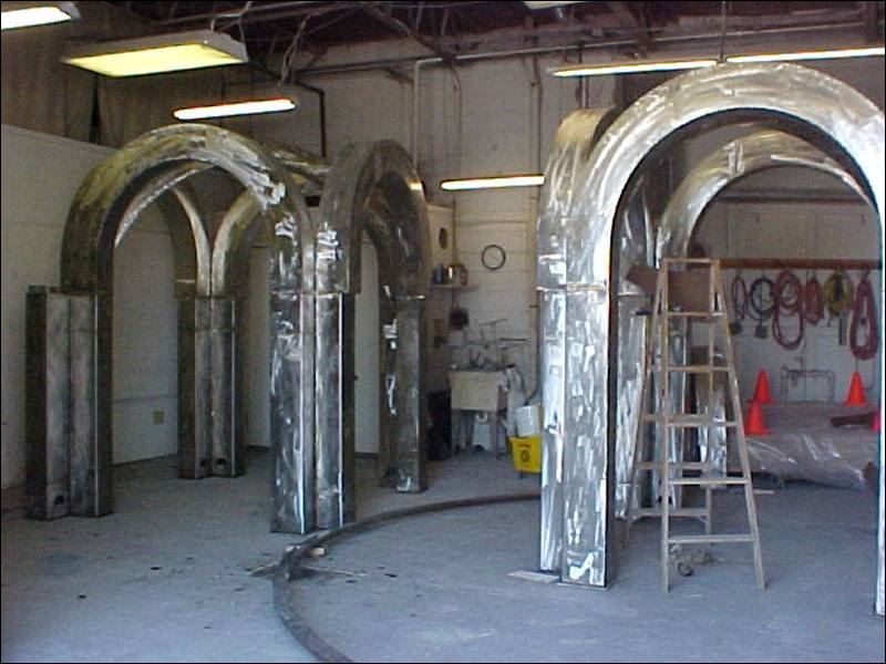 A cluster of wooden arches is being crafted at Flatlanders Sculpture Supply 