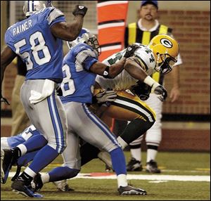 Green Bay running back Najeh Davenport slips by Lions defenders for a 13-yard touchdown run in the third quarter.