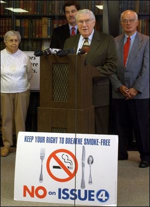 Dr. John Newton, speaking yesterday at Academy of Medicine, and, from left, Dr. Marian Rejent, Dr. Mark Seal, and Dr. Ernest Brookfield join others in urging a 'no' vote on Issue 4.