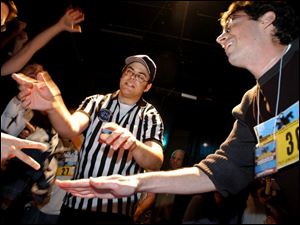 Competing to advance to the round of 32 in a field of 600, Ryan Smith shoots paper and loses to the scissors thrown by Heather Birrell, a 33-year-old fiction writer from Toronto.
