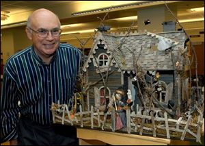 Don Coffey built a dollhouse that has a distinct Halloween theme, with creepy creatures.