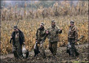 Accompanying Sen. John Kerry, third from left, are fellow goose hunters Rep. Ted Strickland, Bob Bellino of Ducks Unlimited, and Neal Brady, assistant manager of Indian Lake State Park.