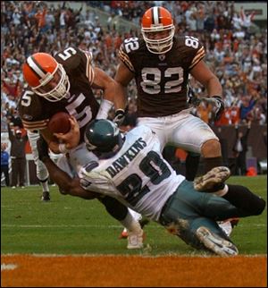 Cleveland quarterback Jeff Garcia bowls over Philadelphia's Brian Dawkins to score a touchdown from four yards out in the fourth quarter, helping the Browns tie the Eagles 31-31 before losing in overtime.