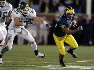 Michigan's Michael Hart gets away from Michigan State safety Eric Smith. Hart carried 33 times for 224 yards. He became the first Wolverine to rush for 1,000 as a true freshman.