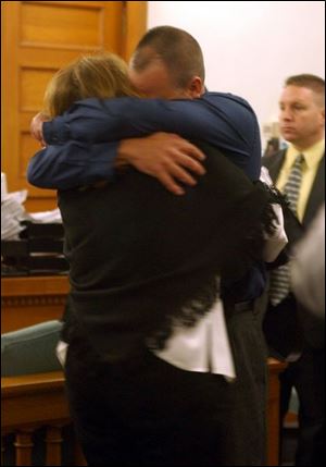 Richard Wisbon, the Libbey High School teacher acquitted of a sexual battery charge, hugs his wife, Lonnie, after the verdict was read in Lucas County Common Pleas Court.
