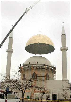 A new 30-foot-high, 18,000-pound dome is placed atop the Islamic Center of Greater Toledo in Perrysburg Township.