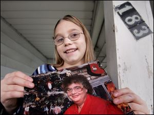 Jenna Pierson of Sherman Elementary School holds a photo of her grandmother. Jenna is thankful for firefighters who came to the rescue a few years ago when her grandmother had trouble bleeding.