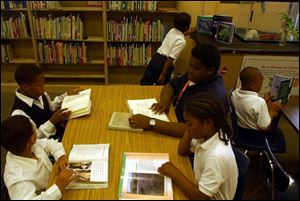 Students at Toledo Public Schools' Lincoln Academy for Boys spend some quiet time with books in the school's library.