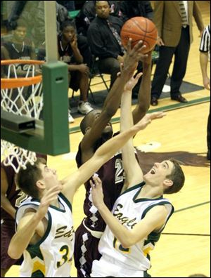 Scott's Darrion Griffin and Clay's Wes Taylor (34) and A.J. Achter (12) compete for a rebound last night. Griffin had 14 points and 10 rebounds for the unbeaten Bulldogs.