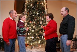 Roger Allmandinger, left, Kathy Kusisto-Allmandinger, and Anne and Bill Oldaker have spent past Christmases together.