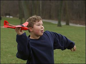 ROV FLYING HIGH 12/31/04 PHOTO BY LORI KING Since sledding is no longer an option due to mild temps, Holland, OH resident Anthony Frohlich, 9, instead flies his air hog airplane he recieved for Christmas during a family outing at Wildwood Metropark.