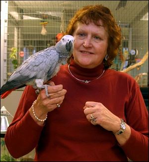 Riley, an African gray parrot, and technical supervisor Marge Malinowski form the welcoming committee for the more than 5,000 students who tour the Life Lab at Lourdes College each year. 