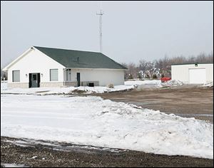 A former golf course clubhouse, left, and barn are being used as a meeting center and rescue-department garage by the township.