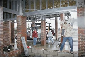 Work on the entryway of Wood Haven Health Care on East Gypsy Lane Road is in progress.