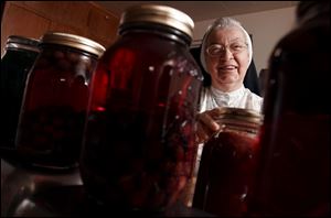 Sister Charlotte Rita cans grape juice, pickles, and peaches at the St. Ursula Academy Convent.