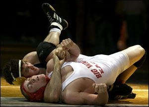 James Kettinger of St. John's (160 pounds) works for a pin against Big Walnut's David Bowman. Kettinger won the title.
