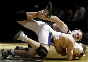 Delta's Jared Evans takes down Hilliard Davidson's Jimmy Millar in the 103-pound championship match at the Perrysburg Invitational. Evans won with a pin in the first period.