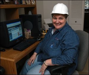 Dorothy Sutter, in a hard hat symbolizing her portfolio's role in industry, chose her stocks in honor of her hometown roots.