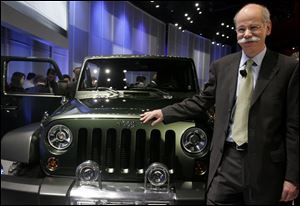 Dieter Zetsche, president and CEO of the Chrysler group of DaimlerChrysler AG, shows off the new diesel-powered Gladiator model at the North American International Auto Show at Cobo Center in downtown Detroit. The auto show opens Saturday and runs through Jan. 23.