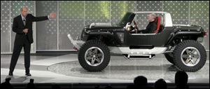 Dieter Zetsche, Chrysler's president and chief executive, introduces the Jeep Hurricane. The concept vehicle's front tires can be turned inward and rear tires outward, allowing the Hurricane to spin in a circle, giving it a turn radius of zero.