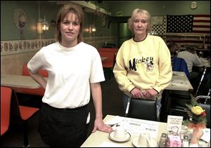 Waitress Lisa Rhodes, left, and assistant manager Barbara Jacquot work at White Lattice Cafe, where police ordered removal of ashtrays Friday after they found smoking in the building.