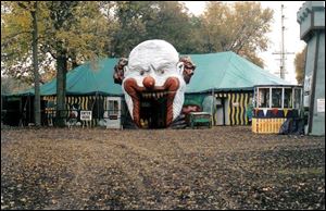 A menacing clown greets visitors entering the mobile haunted
house at the Haunted Hydro Dark Attraction Park in Fremont.