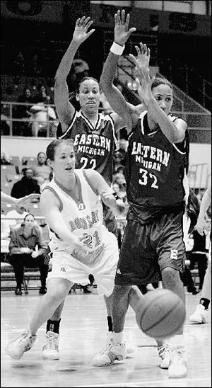 With Eastern Michigan towering above her, BG's Casey McDowell makes a pass against sisters Kristen and Ryann Kilgore.