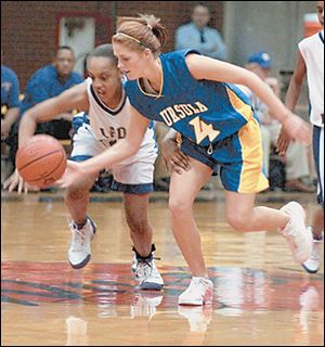 Waite's Shareese Ulis, left, and St. Ursula's Emily Florian scramble for a loose ball last night. Ulis scored nine points and Florian had 10.