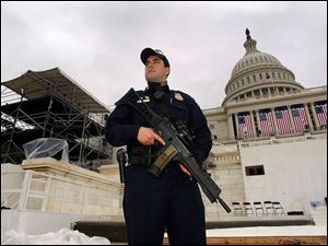 A police officer guards the preparations for President Bush's second inauguration ceremonies. 