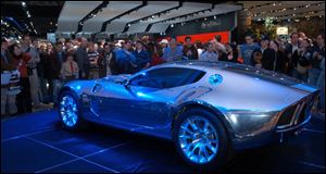 First-day crowds gather around Ford Motor Co. s low-slung Shelby GR-1 concept car at the Detroit car exposition. The auto show in the Cobo Center runs through Sunday.