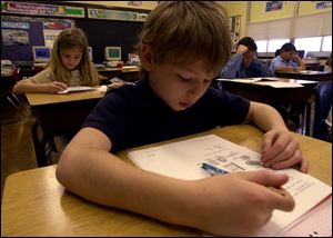 Johnny Przybylski, a fourth grader at Harvard Elementary School, works on a Pre-Ohio Assessment Test to gauge how well he is prepared for the upcoming Ohio Proficiency Tests.