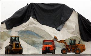  A city of Toledo truck is refilled with road salt from the salt pile on Water Street. Although northwest Ohio has had more snow and ice than average this season, Toledo officials report they have used only about a third of their 65,000-ton stockpile.