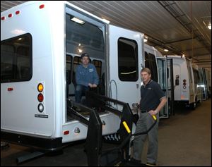 Two of Transportation Equipment Sales Corp. employees are Mike Shine, left, a body repair technician, and Steve Dreier, vice president of school and child care buses and vans.