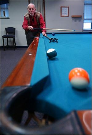NBR senior02p D -- Fritz Geghring watches his shot head for the pocket. The 84-year-old Toledo resident was playing pool at the Sylvania Senior Center Wednesday, 02/02/05. The Blade/Andy Morrison
