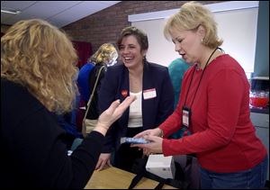 At a Maumee Valley Chapter of Romance Writers meeting, Denise Koch, left, and Lori Karayianni, and Jennie Moening discuss Ms. Koch's book that's coming out under the name Denise Lynn.
