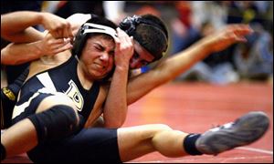 Josh Sneyd of Waite gains control of Perrysburg's Justin Flores in the 103-pound sectional final at Rogers. Sneyd won the title with a 9-3 decision.