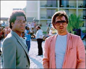 Philip Michael Thomas, left, and Don Johnson in Miami Vice. Executive producer Michael
Mann was responsible for the TV series  landmark style, which included tropical colors,
sport coats worn over T-shirts, carefully trimmed stubble, and a rocking soundtrack.