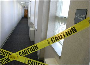 A hallway to the Mercy Hospital chapel, the 1980 crime scene, was taped off shortly after Father Robinson's arrest in April.