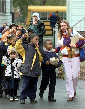 First graders at Hope Tremont Academy, one of Cleveland's voucher schools, and their teacher return from a field trip in 1998. Earlier this month, Gov. Bob Taft proposed expanding the voucher program to the entire state.