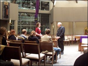 Julie Taylor speaks to Bishop Leonard Blair at a 'listening session' Sunday night with University of Toledo Catholic Student Association members at Corpus Christi University Parish on Dorr Street.