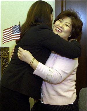 Kay Mi Yeon Moon, left, and her mother, Kyeong Eun Kay Moon, celebrate becoming citizens. The family came to the United States from South Korea more than two decades ago.