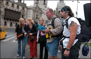 Bianca, Debbie, Susan, Ryan, and Chuck (from left) pause to read a clue in the Plaza de Armas in Lima, Peru, on the special two-hour season premiere of The Amazing Race 7 at 9 tonight.
