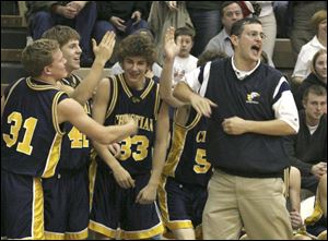 Toledo Christian coach Dave McWhinnie leads his team in cheers as the finals seconds tick off the clock last night.
