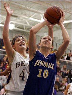 Findlay s Carlee Roethlisberger goes up for a shot as North Royalton s Katie Mastrodonato defends during
the second quarter of their Division I regional semifinal game last night at Norwalk High School.
